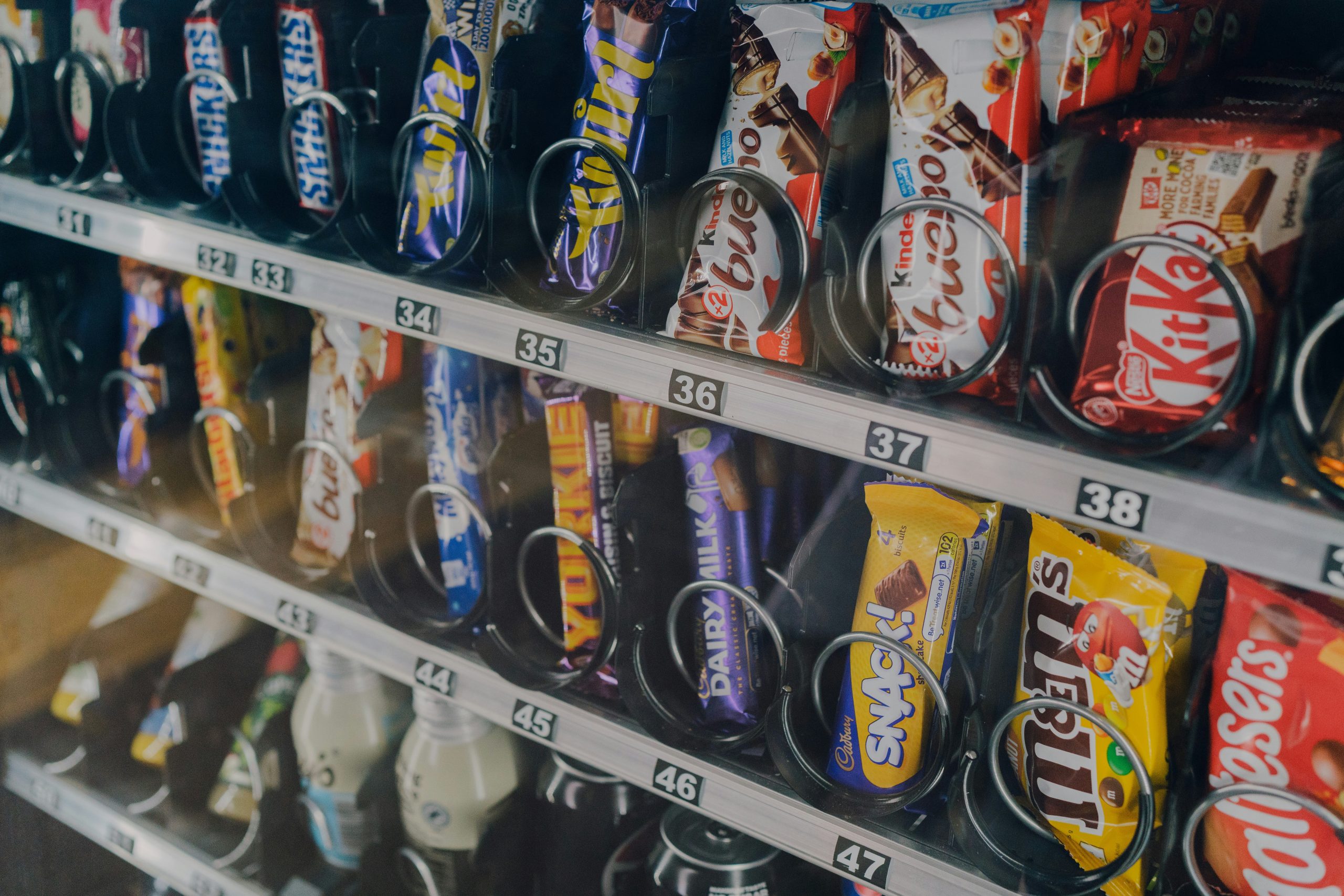 A close-up shot of the chocolate bars in a vending machine rental